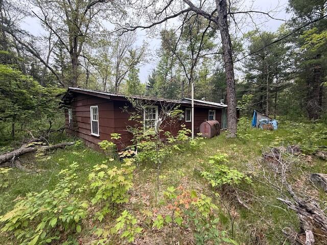 4465 E Old M-63, Luther, MI 49656 - view of front of house with a view of trees