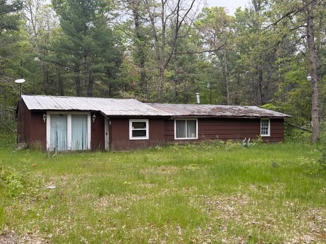 4465 E Old M-63, Luther, MI 49656 - back of property featuring metal roof and a view of trees