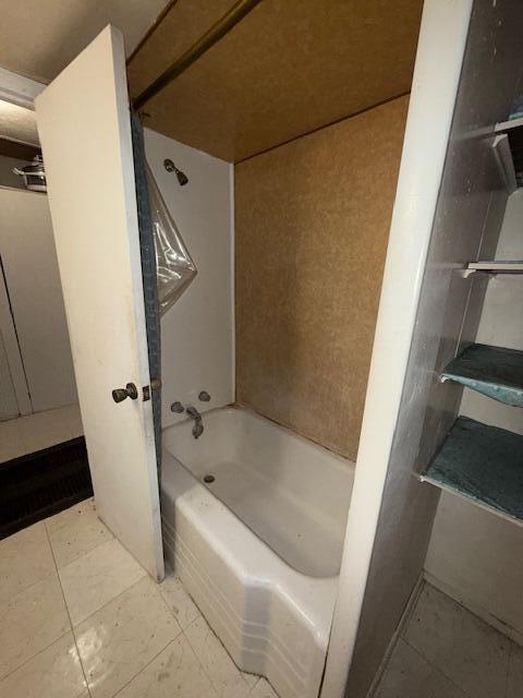 4465 E Old M-63, Luther, MI 49656 - full bathroom featuring shower / bath combination and tile patterned flooring