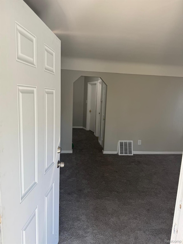 18950 Blackmoor St, Detroit, MI 48234 - unfurnished room with dark colored carpet, arched walkways, and baseboards