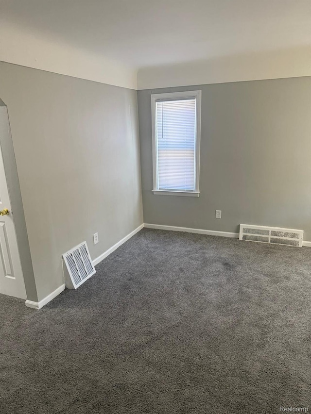 18950 Blackmoor St, Detroit, MI 48234 - spare room featuring dark colored carpet and baseboards