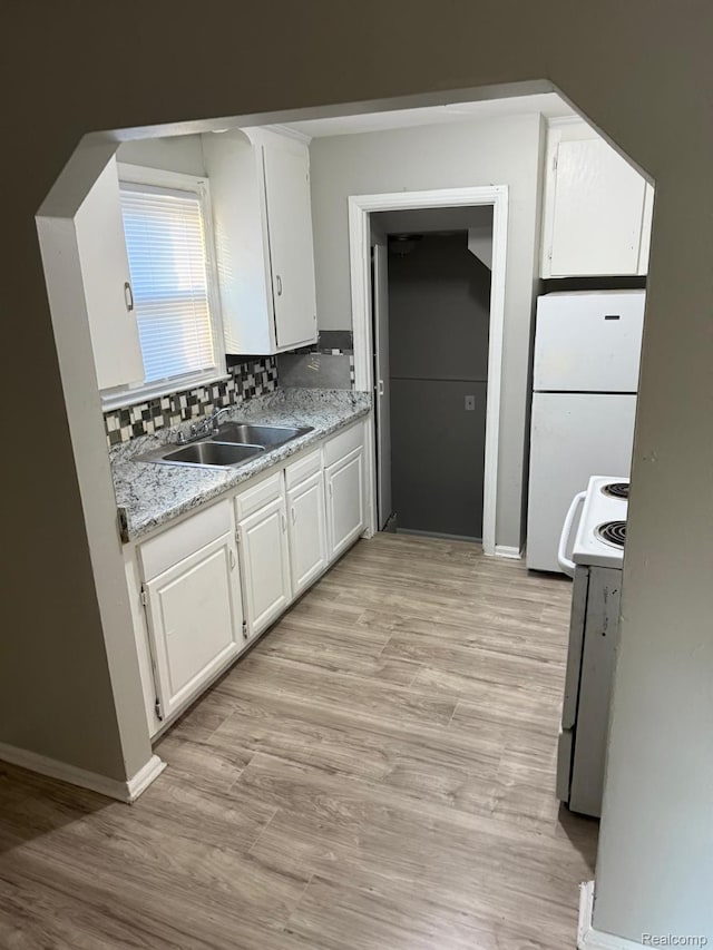 18950 Blackmoor St, Detroit, MI 48234 - kitchen featuring white appliances, white cabinetry, and light wood-style floors