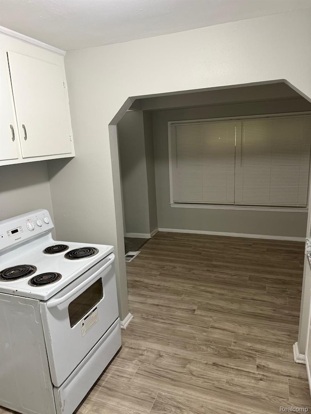 18950 Blackmoor St, Detroit, MI 48234 - kitchen with electric stove, white cabinets, baseboards, and light wood-style flooring