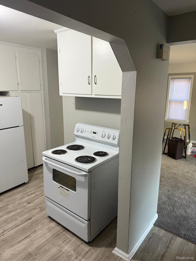18950 Blackmoor St, Detroit, MI 48234 - kitchen featuring white appliances, white cabinetry, and light wood-type flooring