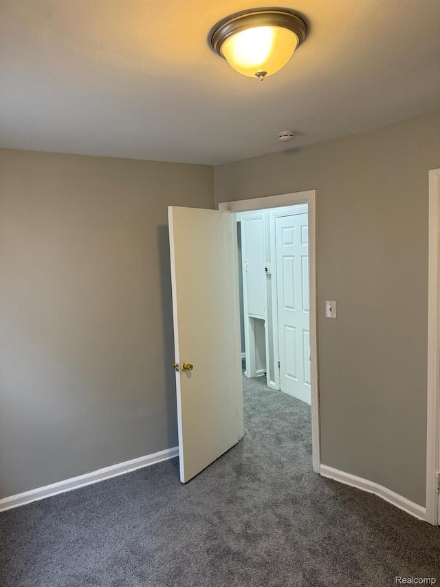 18950 Blackmoor St, Detroit, MI 48234 - empty room featuring carpet floors, a smoke detector, and baseboards