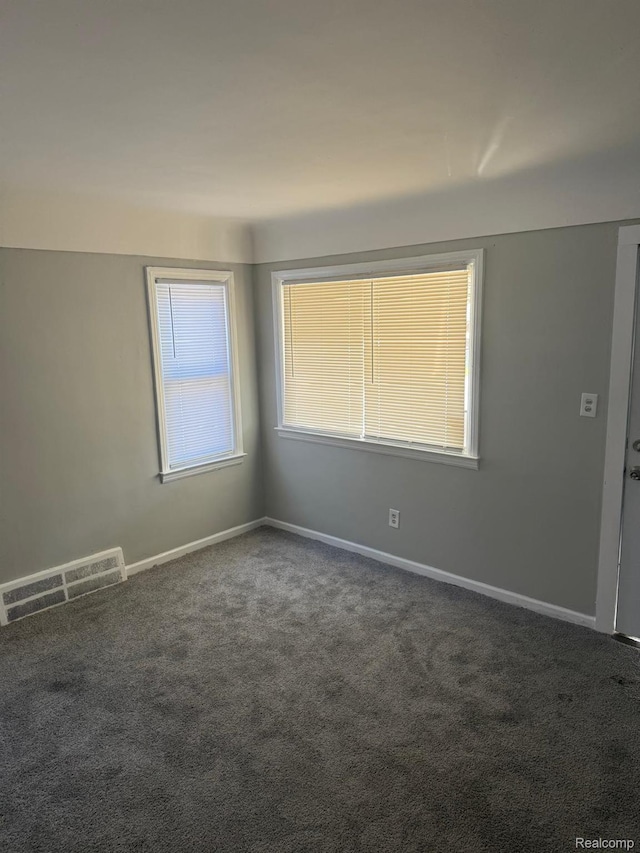 18950 Blackmoor St, Detroit, MI 48234 - empty room featuring dark colored carpet and baseboards