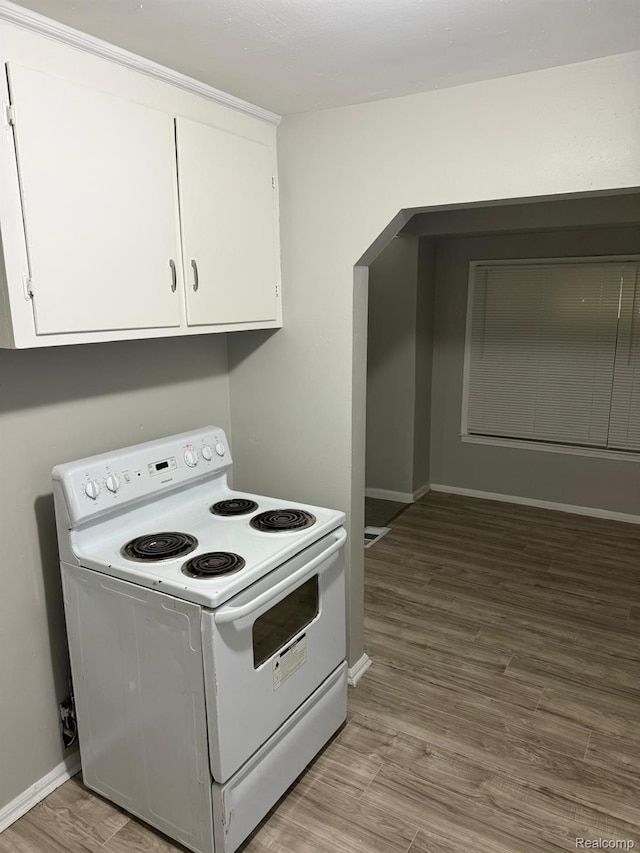 18950 Blackmoor St, Detroit, MI 48234 - kitchen with white range with electric cooktop, white cabinetry, baseboards, and wood finished floors
