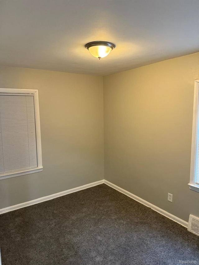 18950 Blackmoor St, Detroit, MI 48234 - spare room with dark carpet and baseboards