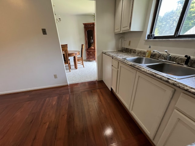 2323 Page Ave, Ann Arbor, MI 48104 - kitchen featuring a sink, dark wood-style flooring, baseboards, and white cabinetry