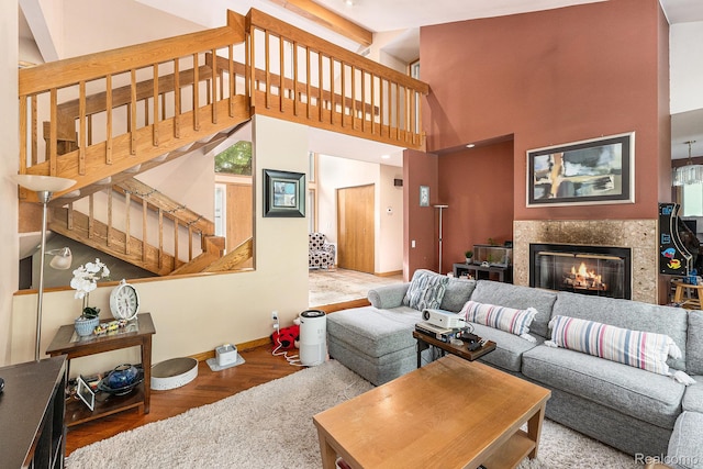 5130 Whitlow Ct, Commerce Twp, MI 48382 - living room featuring stairway, a high end fireplace, baseboards, wood finished floors, and high vaulted ceiling