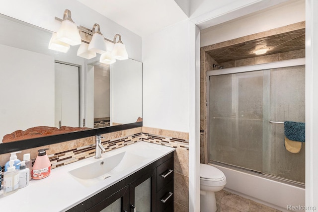 5130 Whitlow Ct, Commerce Twp, MI 48382 - bathroom with vanity, toilet, enclosed tub / shower combo, tile patterned flooring, and tile walls
