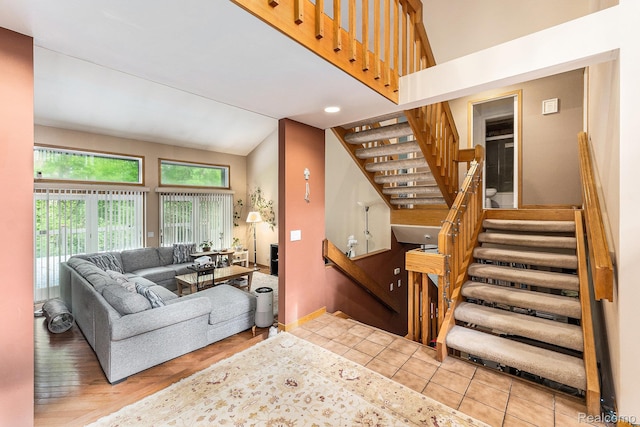 5130 Whitlow Ct, Commerce Twp, MI 48382 - living area with stairs, lofted ceiling, recessed lighting, and baseboards