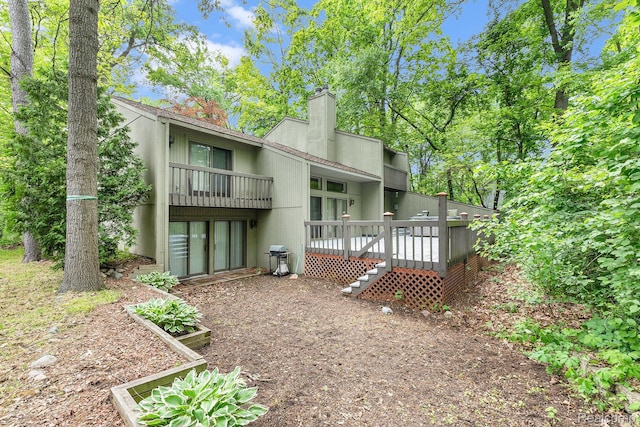 5130 Whitlow Ct, Commerce Twp, MI 48382 - back of house with a chimney and a deck