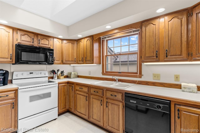 601 Churchgrove Rd, Frankenmuth, MI 48734 - kitchen with black appliances, a sink, brown cabinetry, recessed lighting, and light countertops