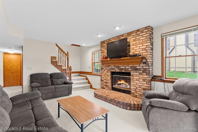 601 Churchgrove Rd, Frankenmuth, MI 48734 - carpeted living room featuring stairs, a fireplace, and recessed lighting