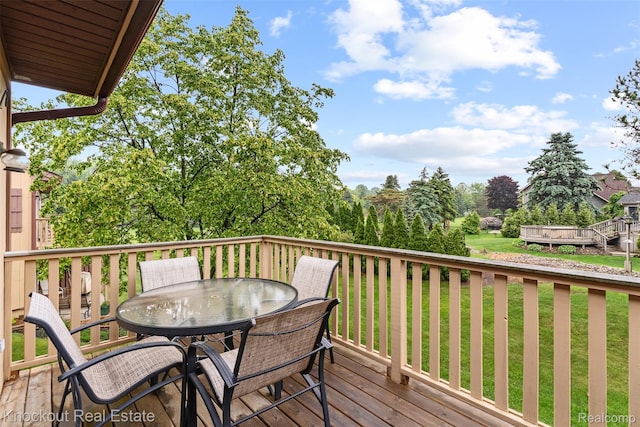 601 Churchgrove Rd, Frankenmuth, MI 48734 - wooden terrace featuring outdoor dining space and a lawn