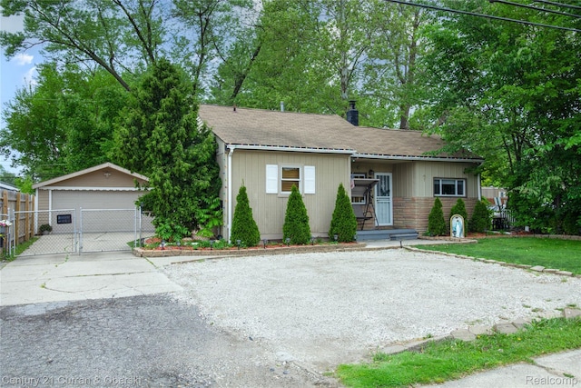 7641 N Inkster Rd, Westland, MI 48185 - bungalow featuring a chimney, an outbuilding, a detached garage, and a shingled roof