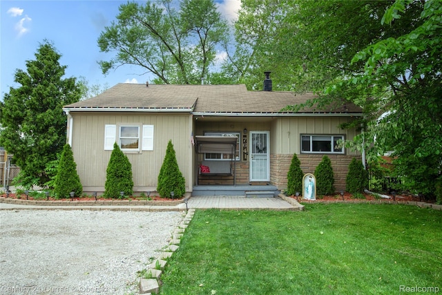 7641 N Inkster Rd, Westland, MI 48185 - view of front of property with a front yard, a chimney, roof with shingles, and stone siding