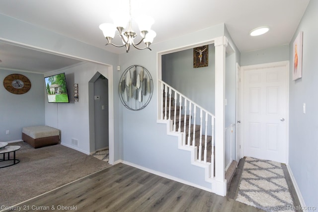 7641 N Inkster Rd, Westland, MI 48185 - entryway with wood finished floors, a chandelier, baseboards, and stairway