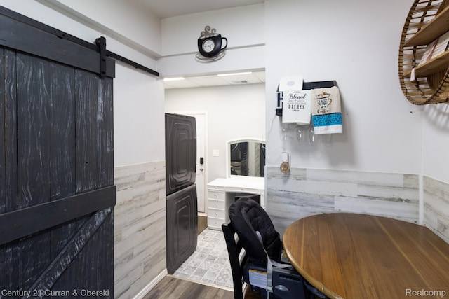 7641 N Inkster Rd, Westland, MI 48185 - kitchen featuring estacked washer and dryer, wood finished floors, a barn door, wainscoting, and a desk