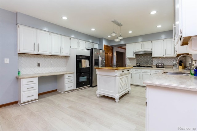 38649 Deerwood Ct, Northville, MI 48167 - kitchen featuring a sink, appliances with stainless steel finishes, backsplash, white cabinets, and light wood finished floors