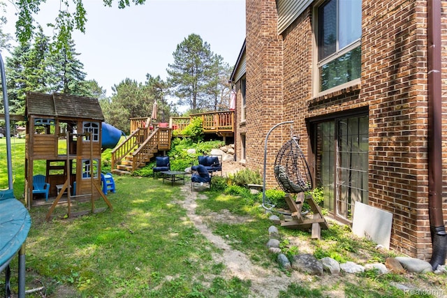 38649 Deerwood Ct, Northville, MI 48167 - view of green lawn with a playground and a wooden deck
