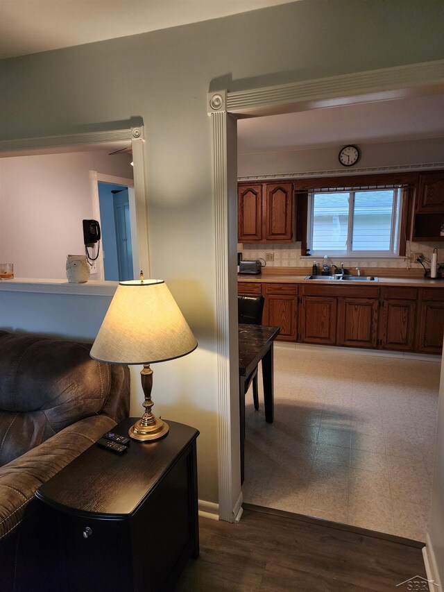 2285 Nebraska Ave, Saginaw, MI 48601 - kitchen with a sink, brown cabinetry, tasteful backsplash, light wood-style floors, and light countertops