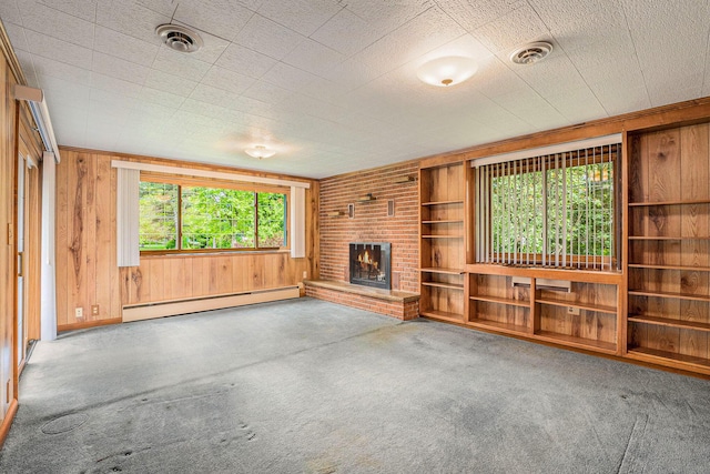 1269 Potomac Dr, Rochester Hills, MI 48306 - unfurnished living room with a baseboard radiator, carpet flooring, healthy amount of natural light, wood walls, and a fireplace