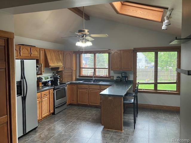 161 Fourth, Harbor Beach, MI 48441 - kitchen featuring appliances with stainless steel finishes, a sink, premium range hood, dark countertops, and a peninsula