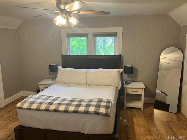 161 Fourth, Harbor Beach, MI 48441 - bedroom featuring lofted ceiling, wood finished floors, ceiling fan, and baseboards