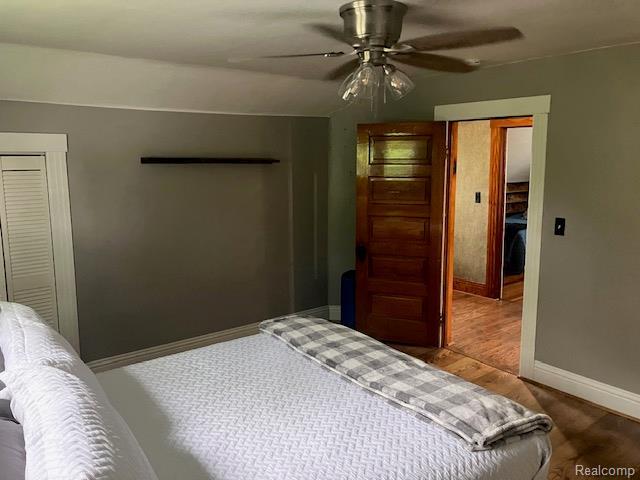 161 Fourth, Harbor Beach, MI 48441 - bedroom with baseboards, wood finished floors, and a ceiling fan