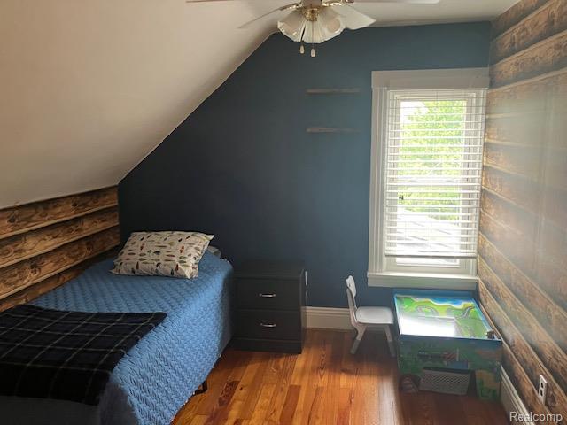 161 Fourth, Harbor Beach, MI 48441 - bedroom with wood finished floors, lofted ceiling, ceiling fan, and baseboards