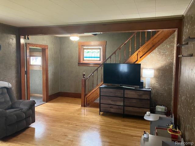 161 Fourth, Harbor Beach, MI 48441 - living room featuring light wood-style floors, stairway, plenty of natural light, and baseboards