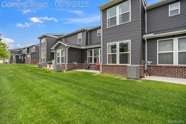 4782 Broomfield Way, Lake Orion, MI 48359 - back of property with brick siding, cooling unit, a yard, and a residential view