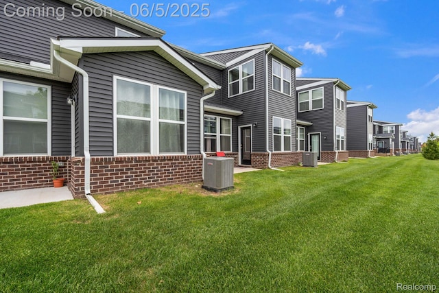 4782 Broomfield Way, Lake Orion, MI 48359 - back of house with central AC unit, a lawn, and brick siding
