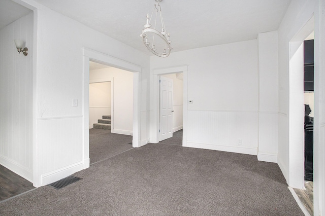 1702 Charles Ave, Kalamazoo, MI 49048 - spare room with dark colored carpet and a chandelier