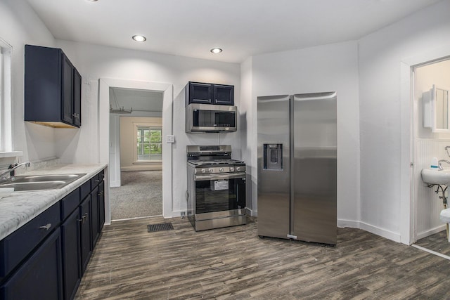 1702 Charles Ave, Kalamazoo, MI 49048 - kitchen featuring appliances with stainless steel finishes, a sink, dark wood-style floors, light countertops, and baseboards