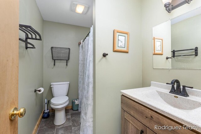 4160 Knapp Valley Dr NE, Grand Rapids, MI 49525 - bathroom with vanity, toilet, and baseboards