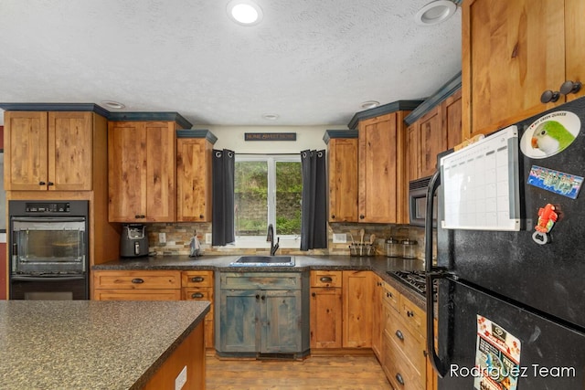 4160 Knapp Valley Dr NE, Grand Rapids, MI 49525 - kitchen featuring black appliances, a sink, dark countertops, backsplash, and recessed lighting