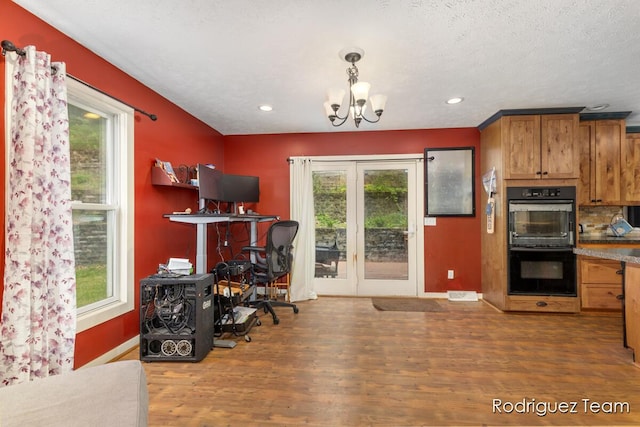 4160 Knapp Valley Dr NE, Grand Rapids, MI 49525 - kitchen with healthy amount of natural light, a desk, a chandelier, wood finished floors, and recessed lighting