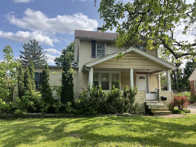2107 Jackson Ave, Ann Arbor, MI 48103 - view of front of house featuring a front lawn, a chimney, and covered porch