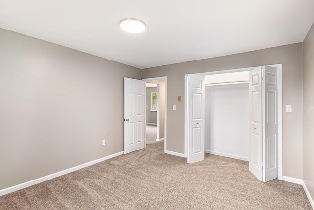 6900 Welch Lake Rd, Grass Lake, MI 49240 - unfurnished bedroom with light colored carpet, baseboards, and a closet