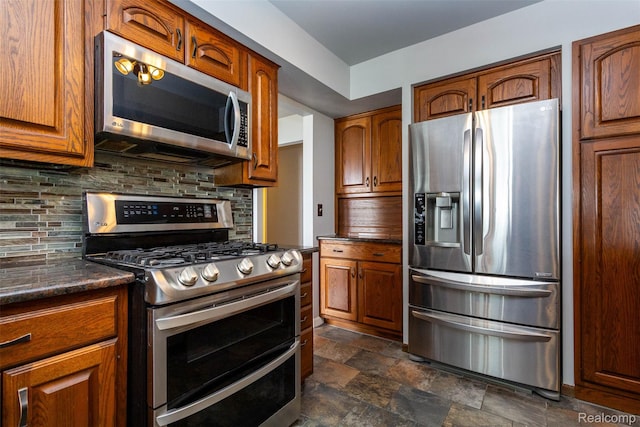 28220 Swan Island Dr, Grosse Ile, MI 48138 - kitchen featuring appliances with stainless steel finishes, stone finish floors, decorative backsplash, and brown cabinetry