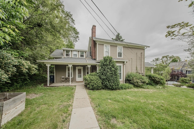 414 W Summit St, Ann Arbor, MI 48103 - view of front facade with a chimney, a front yard, and a porch