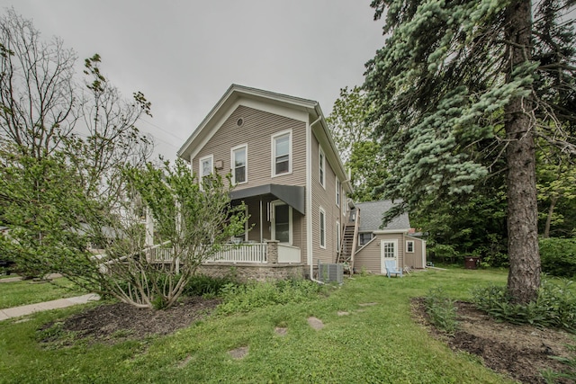414 W Summit St, Ann Arbor, MI 48103 - view of front facade with covered porch, a front yard, and an outbuilding
