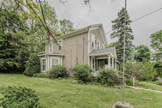 414 W Summit St, Ann Arbor, MI 48103 - view of side of property featuring a lawn and a chimney