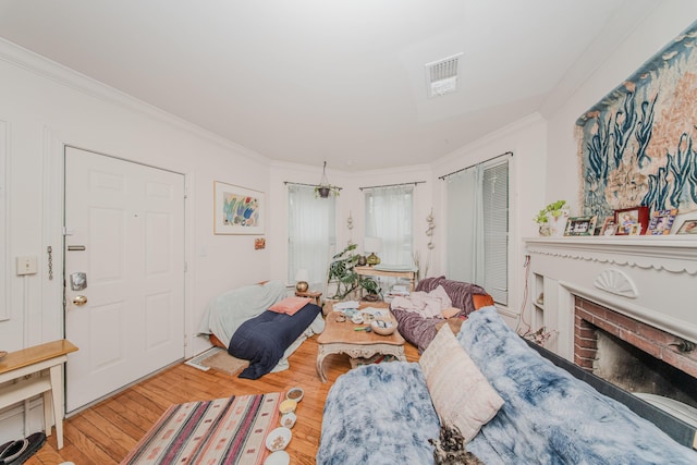 414 W Summit St, Ann Arbor, MI 48103 - living room with crown molding, wood finished floors, and a brick fireplace