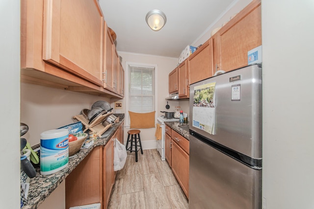 414 W Summit St, Ann Arbor, MI 48103 - kitchen featuring freestanding refrigerator, white gas range oven, crown molding, dark stone countertops, and under cabinet range hood