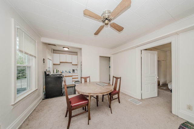 414 W Summit St, Ann Arbor, MI 48103 - dining space with light carpet, ornamental molding, a ceiling fan, and baseboards