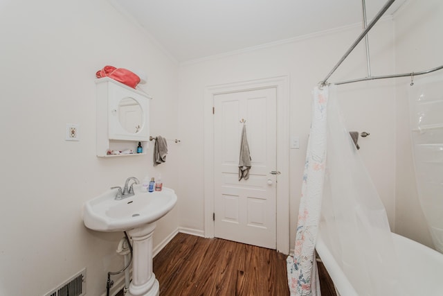 414 W Summit St, Ann Arbor, MI 48103 - bathroom featuring wood finished floors, ornamental molding, curtained shower, and a tub to relax in